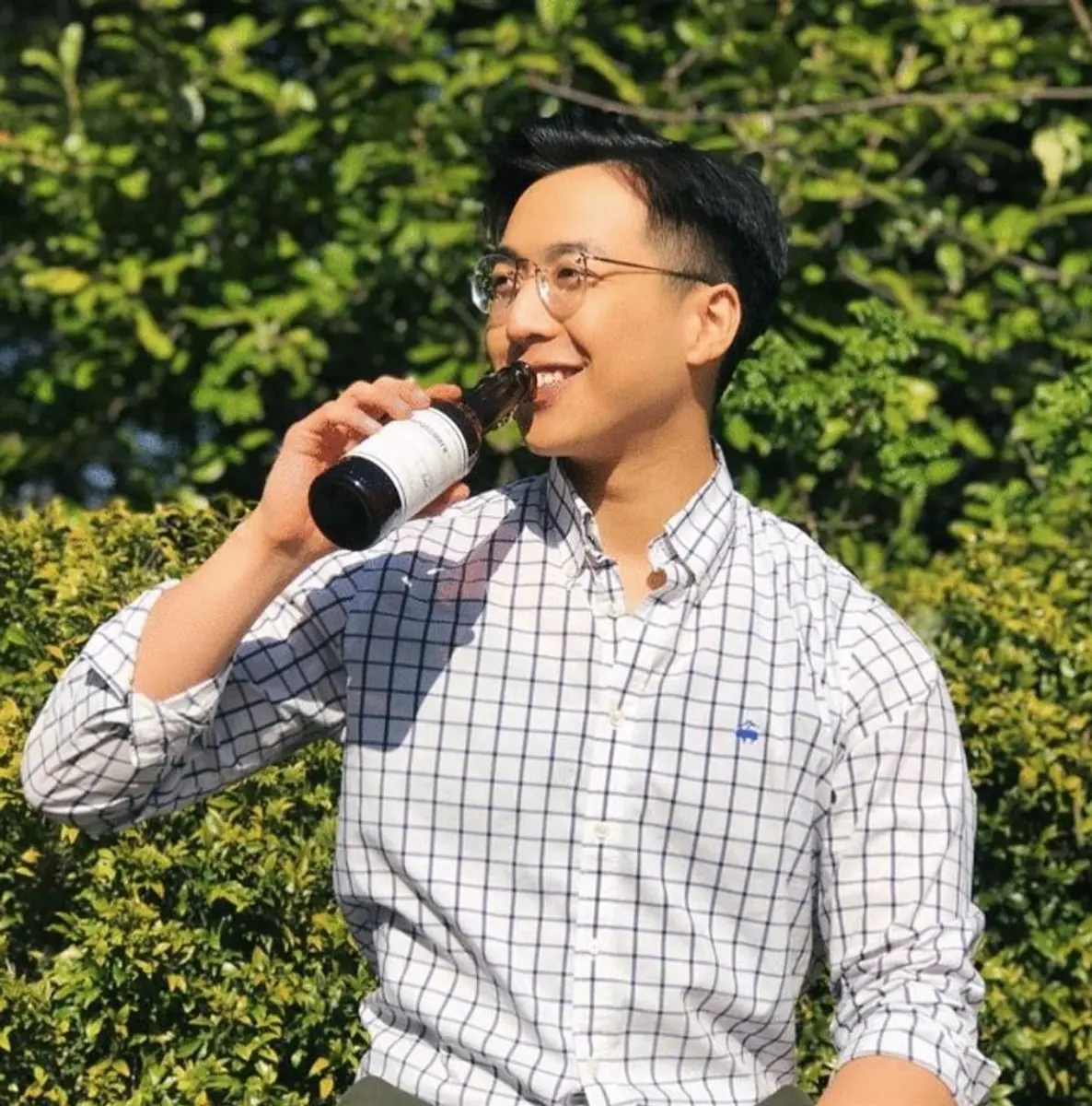 Mark Wong holding an early IMPOSSIBREW bottle outdoors